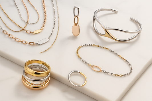 an array of mixed metal jewelry 2025 over a cream background