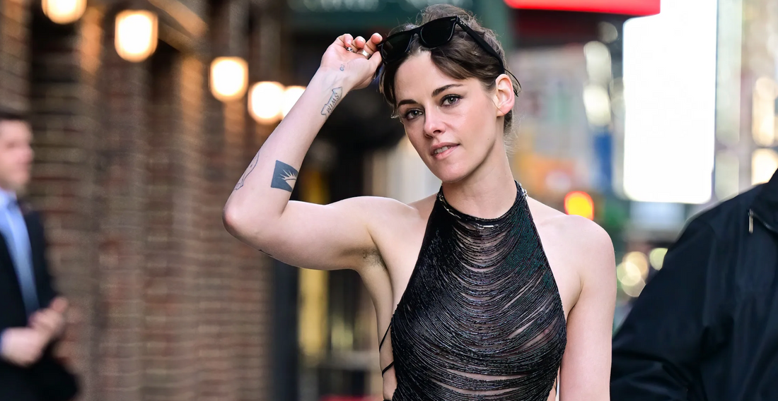 kristen stewart wearing a black top that shows her pierced nipples