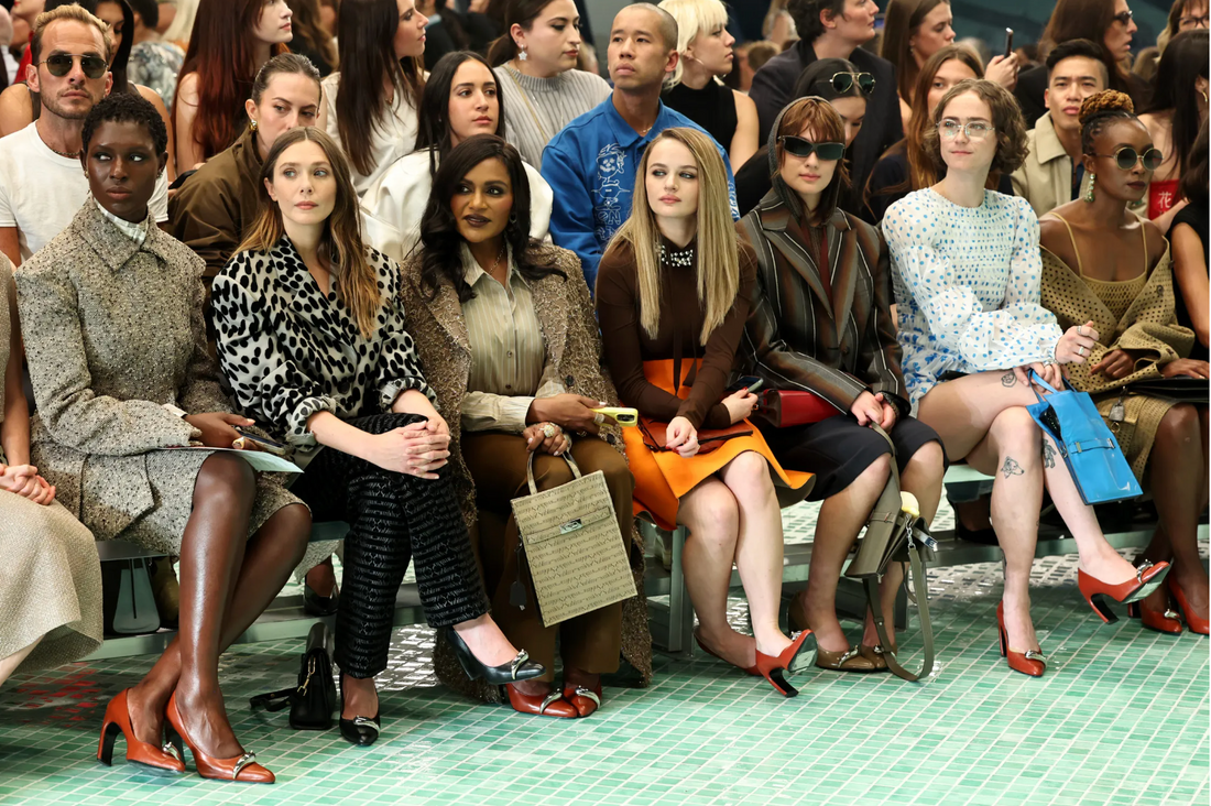 Attendees at Tory Burch’s spring 2025 show wear the designer’s pierced shoes