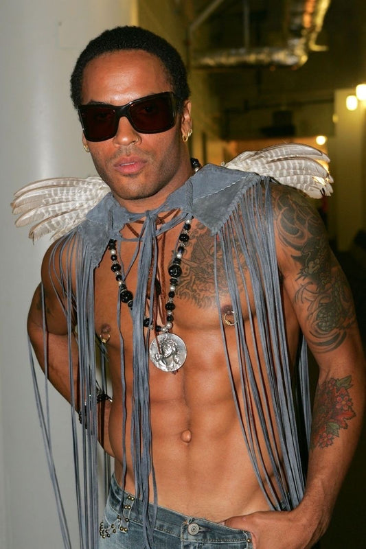 lenny kravitz wearing fake male nipple piercing next to woman wearing fake nipple piercing pasties rocking the pierced nip look