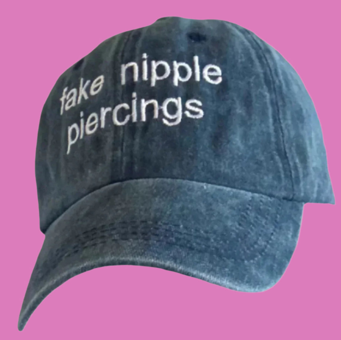 Blue cap with 'fake nipple piercings' text worn by a person.